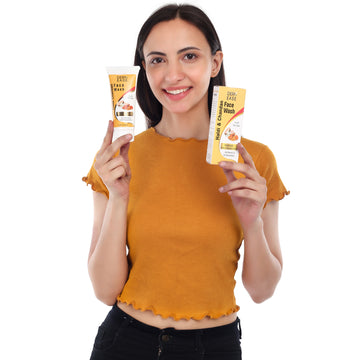 a woman holding a tube of haldi & chandan face wash a woman holding a tube of haldi & chandan face wash