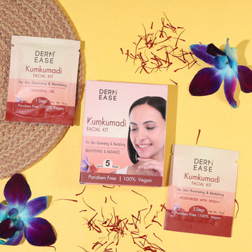 Derm Ease Kumkumadi Facial Kit packaging on a yellow background with flowers and saffron strands. Derm Ease Kumkumadi Facial Kit packaging on a yellow background with flowers and saffron strands.