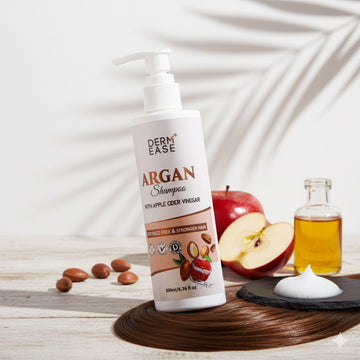 Derm Ease Argan Shampoo bottle with apples and oil on a wooden surface Derm Ease Argan Shampoo bottle with apples and oil on a wooden surface